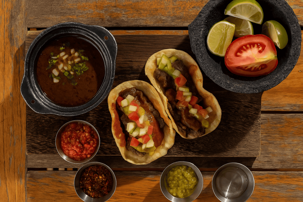 A tray of signature tacos at Naco Taco with diverse fillings on handmade tortillas